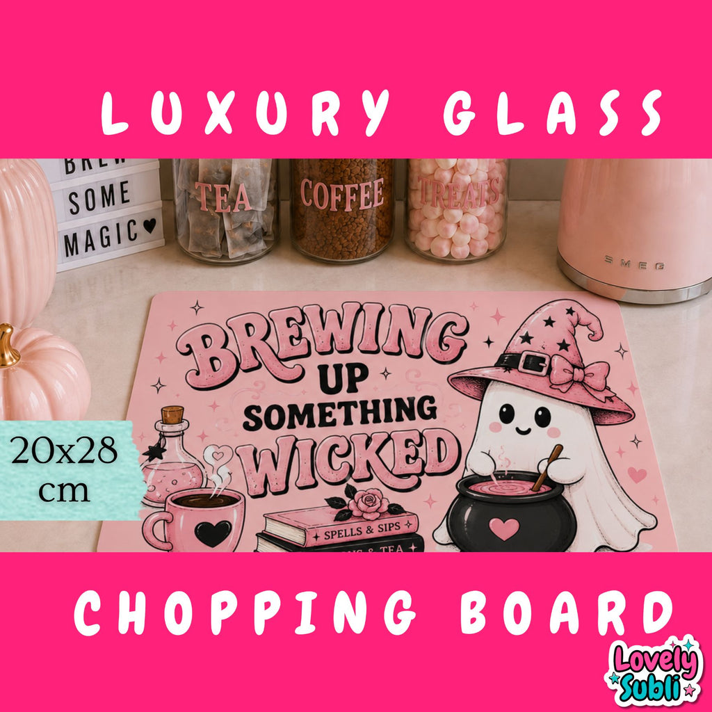 A pink Halloween-themed glass cutting board with a cute ghost and witch illustration, displayed on a countertop with decorative jars and a pink appliance in the background. The image includes promotional text overlays reading 'LUXURY GLASS', '20x28 cm', and 'CHOPPING BOARD'.