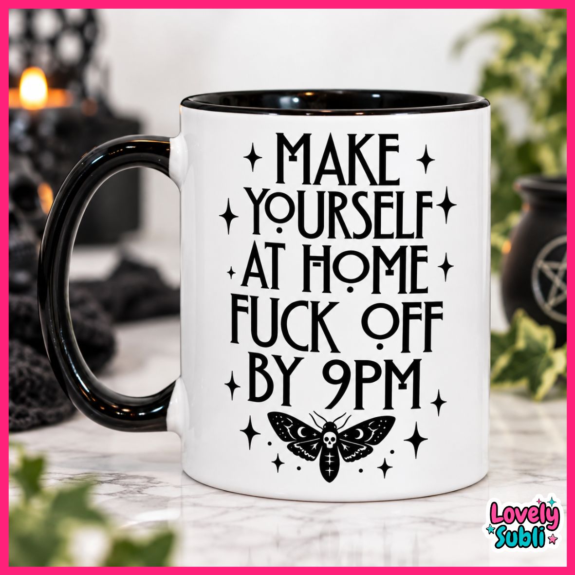 A white ceramic mug with a black handle and black rim, featuring the text 'MAKE YOURSELF AT HOME FUCK OFF BY 9PM' in black lettering with a black moth graphic below. The mug is set on a marble surface with a blurred background containing candles and plants.