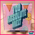A square acrylic sign with a pink background and cute ice cream illustrations, featuring the text 'YOU ABSOLUTE MELT' in large 3D letters. The sign is displayed on a wooden surface with a pink border and a 'Lovely Subli' watermark in the bottom right corner.