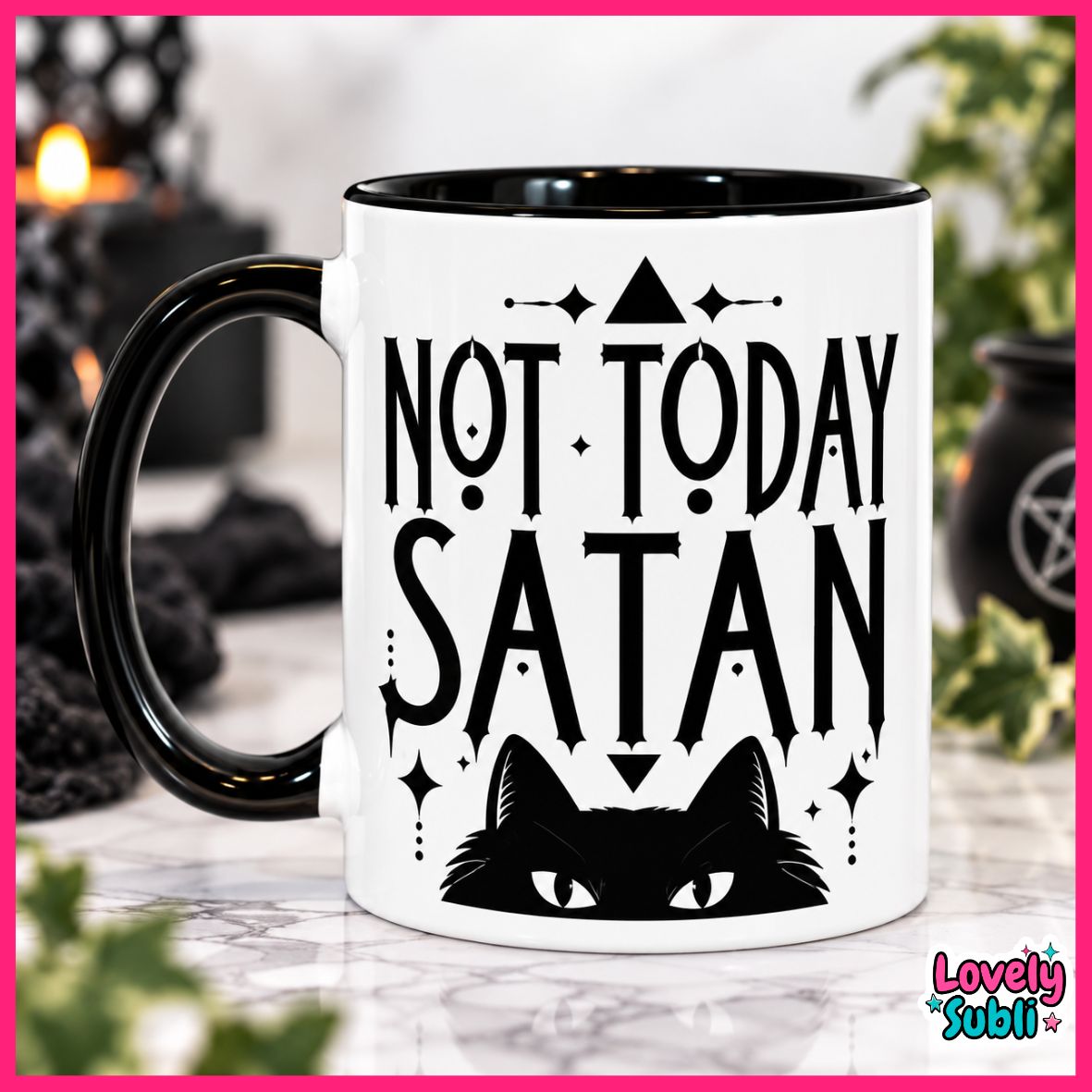 A white ceramic mug with a black handle and black interior, printed with the phrase 'NOT TODAY SATAN' above a black cat face. The mug is shown on a marble-like surface with a blurred dark background and greenery.