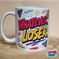 A white ceramic mug with a colorful retro graphic that reads 'WHATEVER, LOSER.' in pink and yellow bubble letters, surrounded by doodle-style shapes, shown on a wooden surface against a beige background.